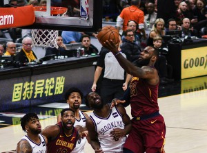 LeBron James (far right) attempts a layup shot against the Nets