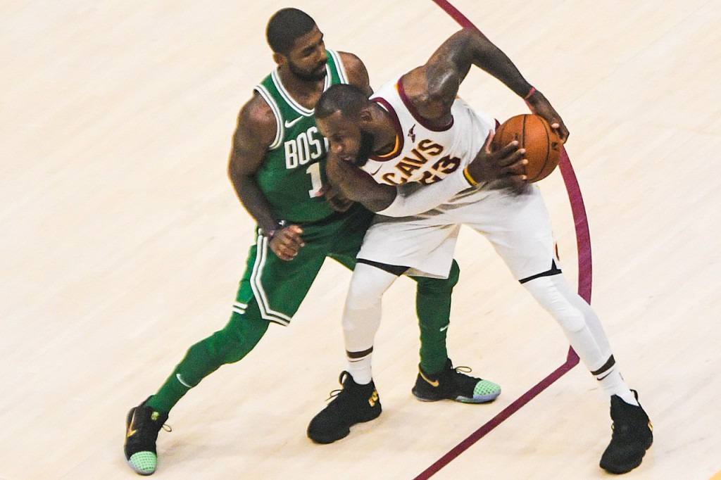 James protects the ball from Kyrie Irving in October 2017. The two were teammates in Cleveland for three seasons.